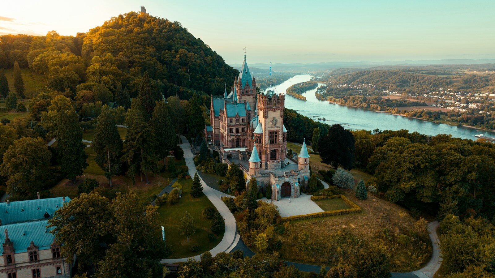 Fairytale castle on a hill overlooking a river